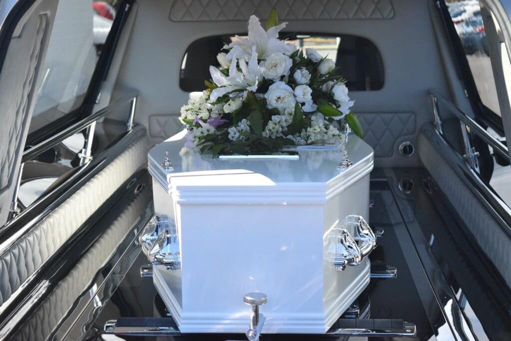 A coffin in a hearse on the way to a funeral