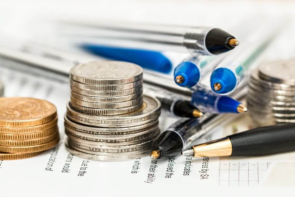 Coins and pens for financial literacy