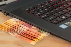 A laptop and money