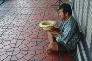 A beggar begging in the street