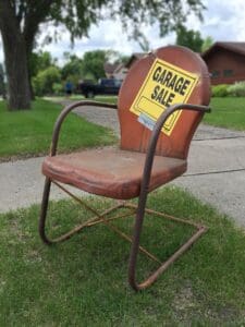 A garage sale sign on an old chair