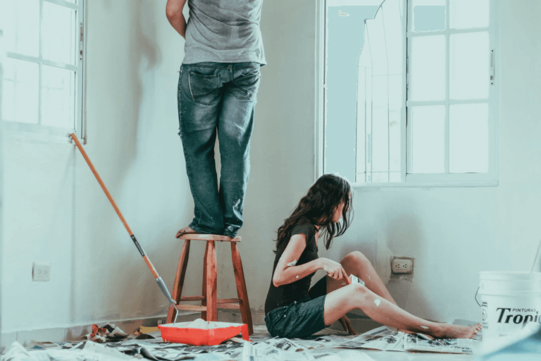 A couple painting and decorating a room