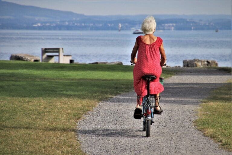 A senior lady riding a bike