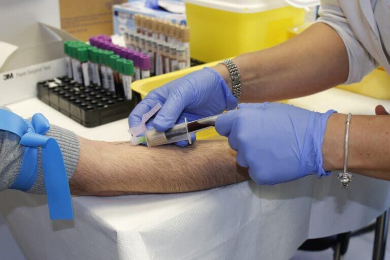 A doctor taking a blood sample