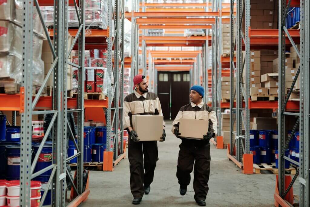 Two members of staff working in a warehouse