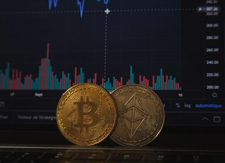 Bitcoins in front of a trading chart on a computer screen
