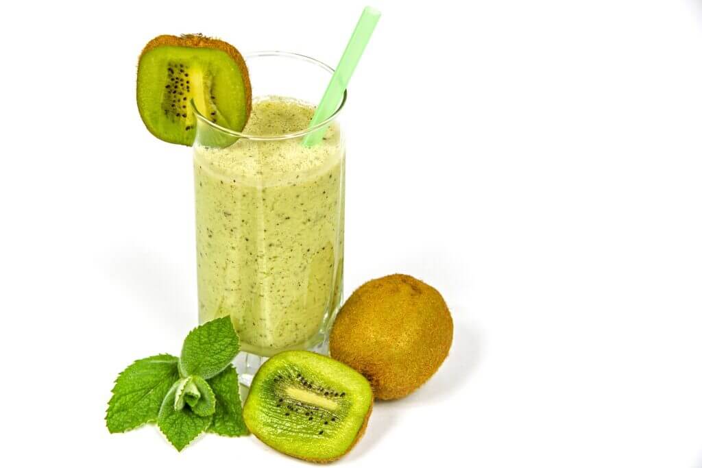 A glass of healthy Kiwi smoothie with mint leaves