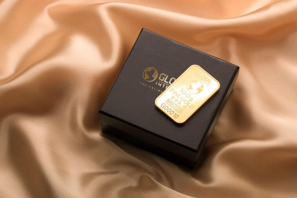 A small gold bar on top of a presentation box