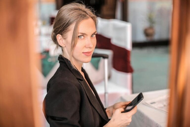 A business woman holding a mobile phone