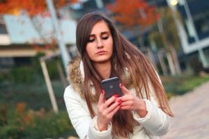 Young woman using an iPhone