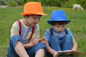 Children enjoying a book in a field